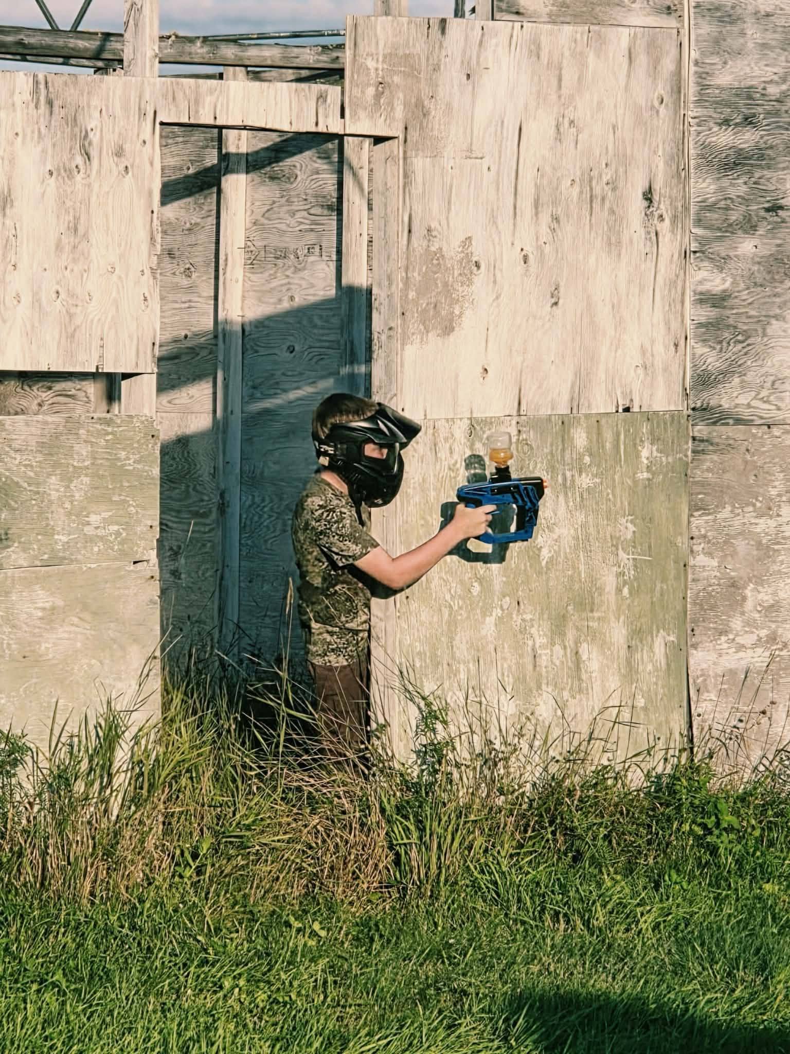 Young player in protective gear taking cover at the field